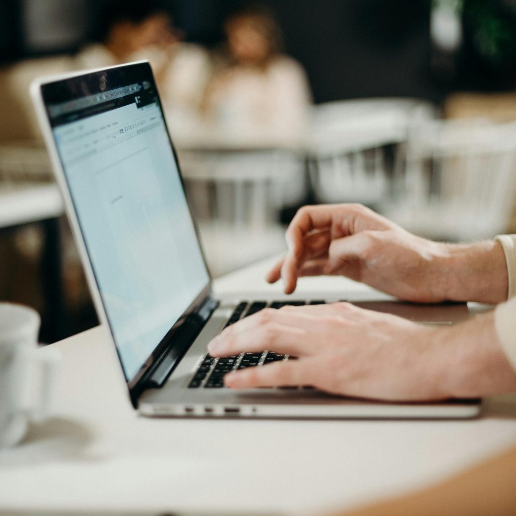 Click here to email me - my email is kiaora@vivianchandra.com. The picture is of a laptop with two hands typing on it.